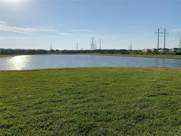 a living room with furniture kitchen view and a wooden floor