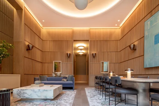 a living room with couches and chandelier