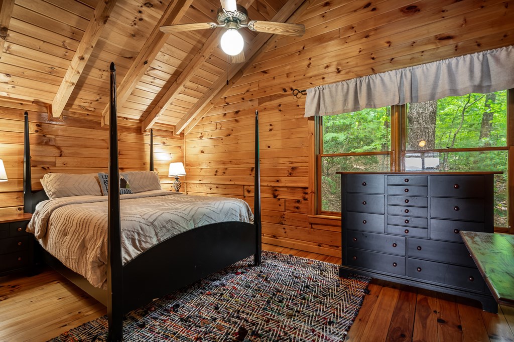 54 Ascherman Court Blue Ridge, GA 30513 - Photo 20 of 48 a bed sitting in a bedroom next to a window