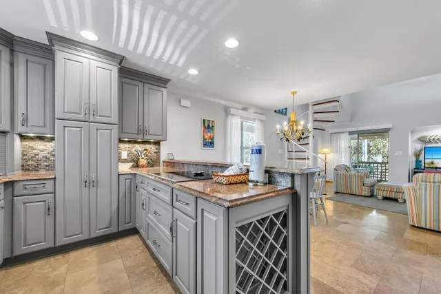 a bathroom with a granite countertop sink and washing machine
