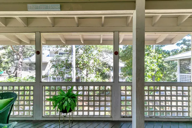 a bedroom with a bed a lamp and a large window