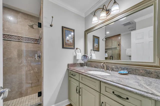 a bedroom with double bed and a chandelier