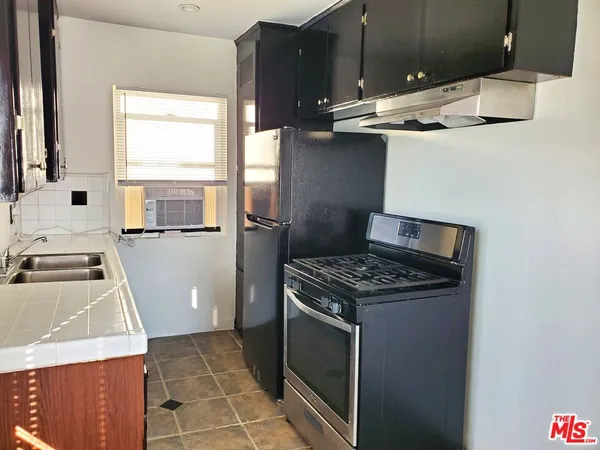a kitchen with a stove and a sink