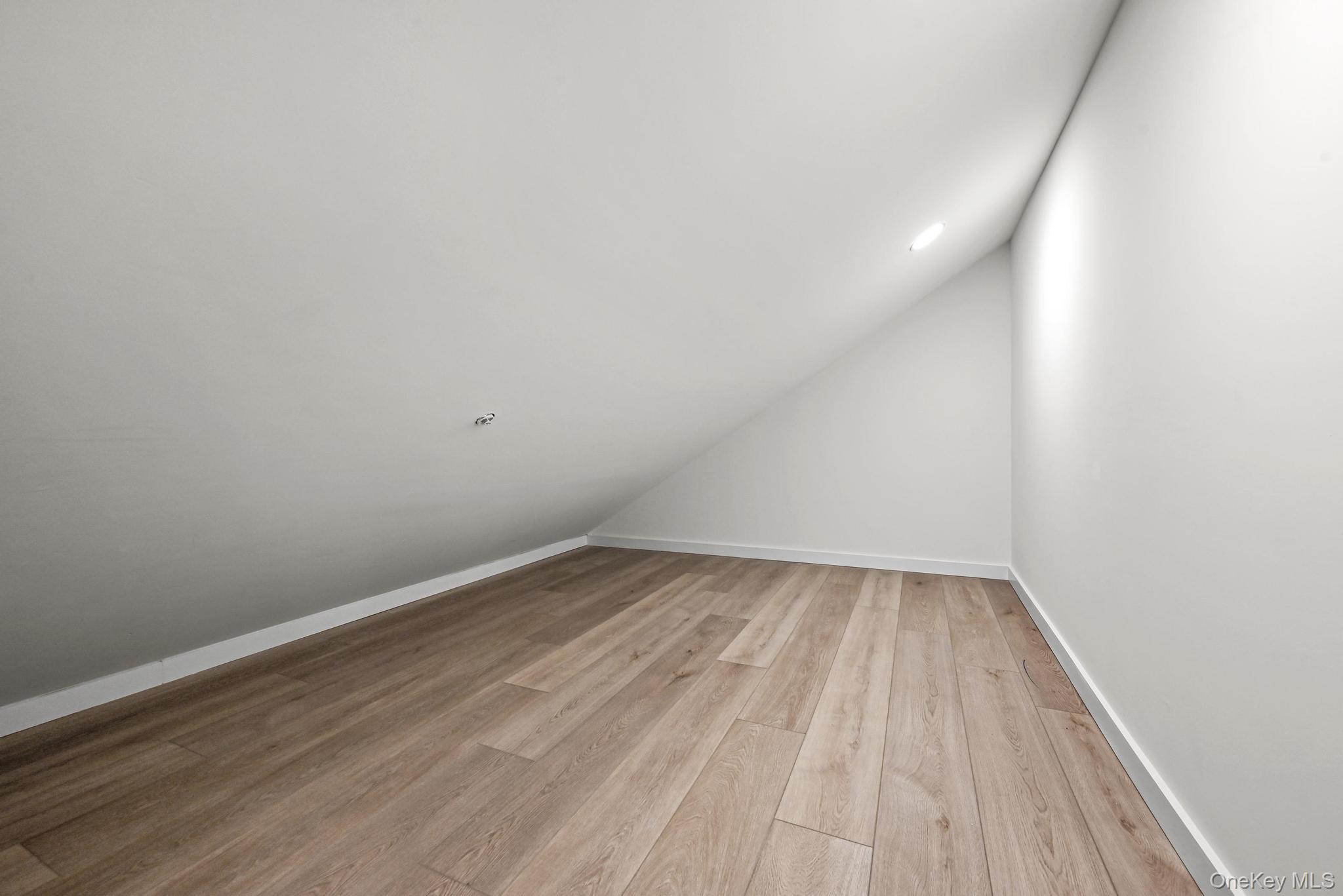 80 Division Street, Unit 3G Patchogue, NY 11772 - Photo 11 of 14 a view of an empty room with wooden floor