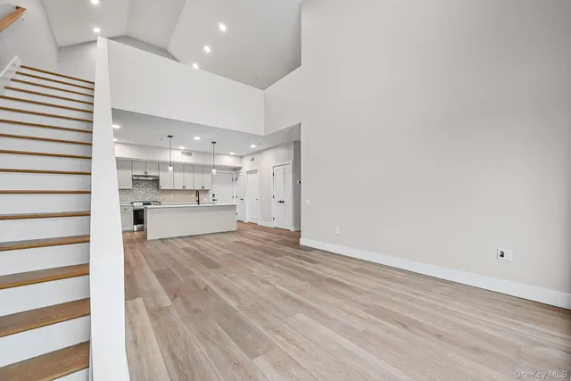a view of a kitchen with a sink and a refrigerator