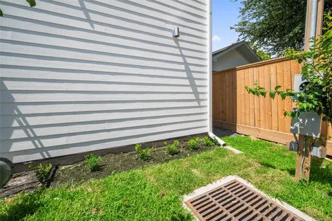 a view of a house with a small yard and flower plants