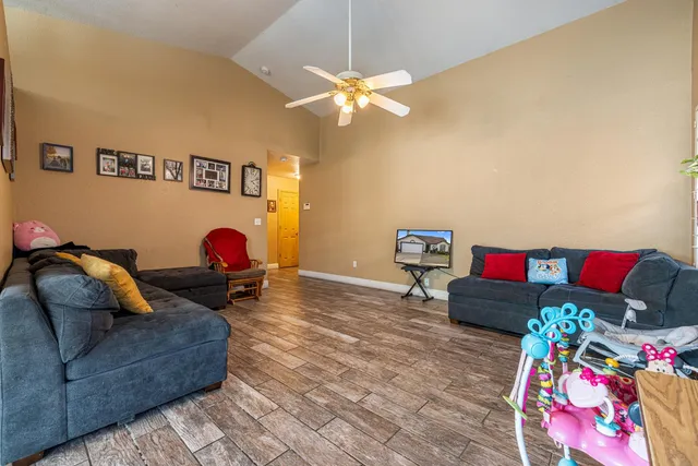 a living room with furniture and a flat screen tv