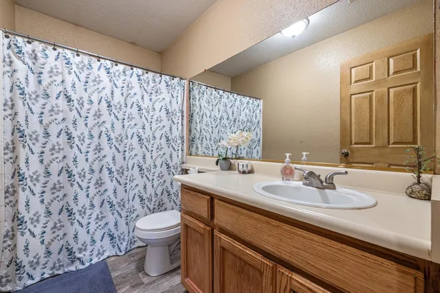 a bathroom with a sink a toilet and a mirror