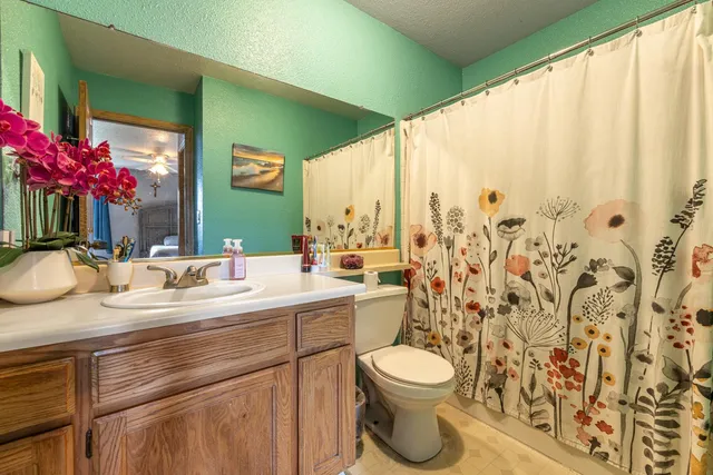a view of bathroom with a toilet sink and mirror