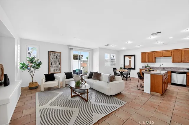 a living room with fireplace furniture and a potted plant