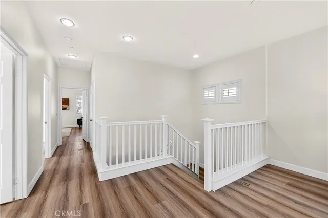 a view of a hallway with wooden floor