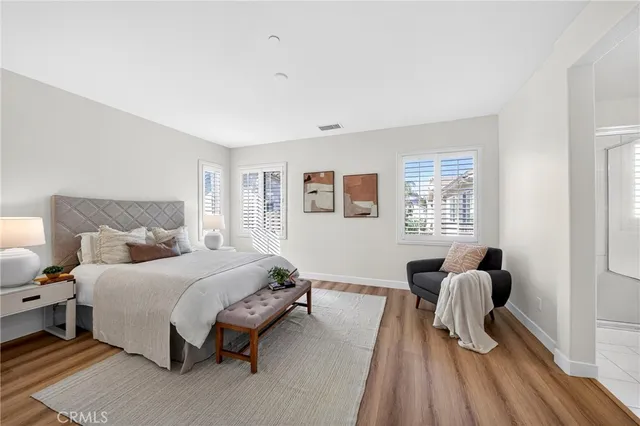 a bedroom with a bed and a large window