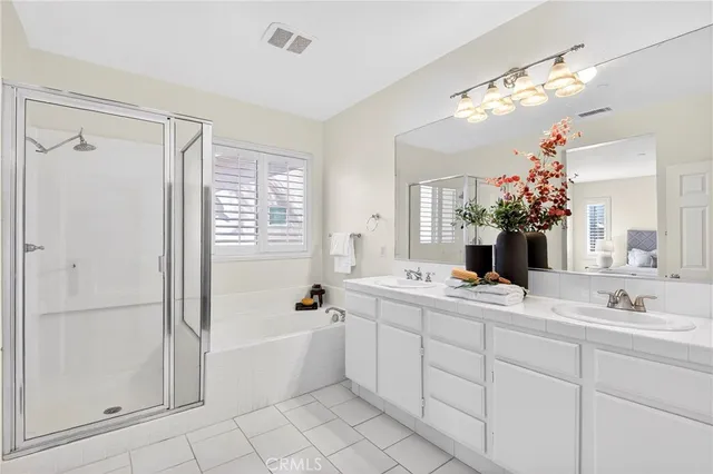 a bathroom with a tub a sink and mirror