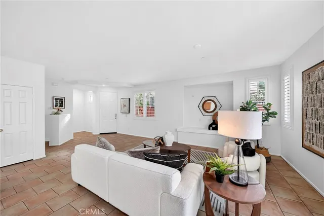 a living room with furniture a table and wooden floor