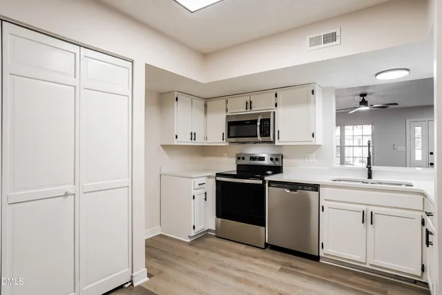 a kitchen with a refrigerator stove and sink