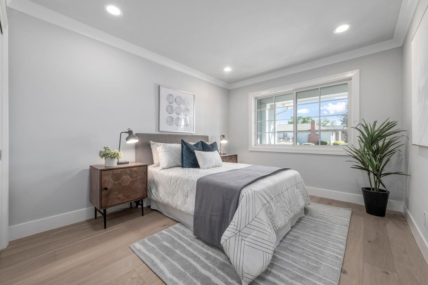 2647 Phillips Avenue Santa Clara, CA 95051 - Photo 11 of 22 a bedroom with a large bed and a potted plant