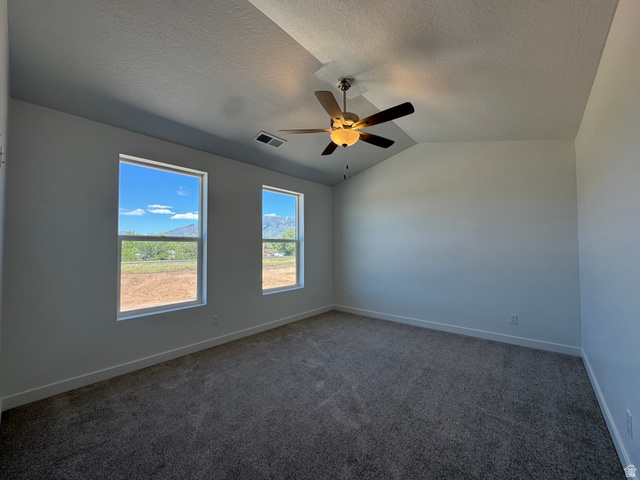 1476 North 1875 West, Unit 152 Layton, UT 84041 - Photo 15 of 20 Spacious room featuring a tray ceiling with a ceiling fan, two windows, gray carpeting, and white baseboards
