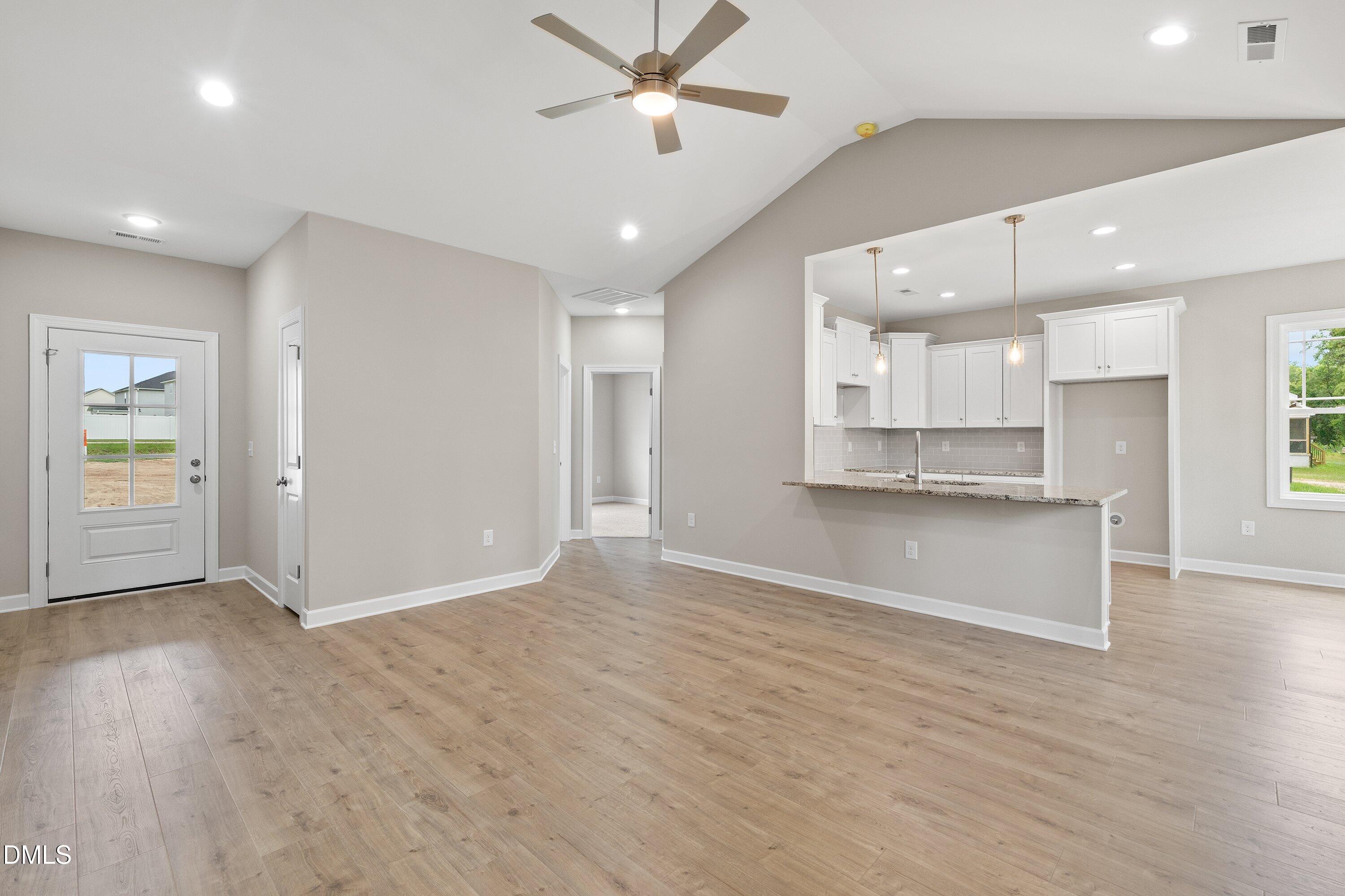 1115 Nor-Am Road Pikeville, NC 27863 - Photo 11 of 40 wooden floor in an empty room with a kitchen