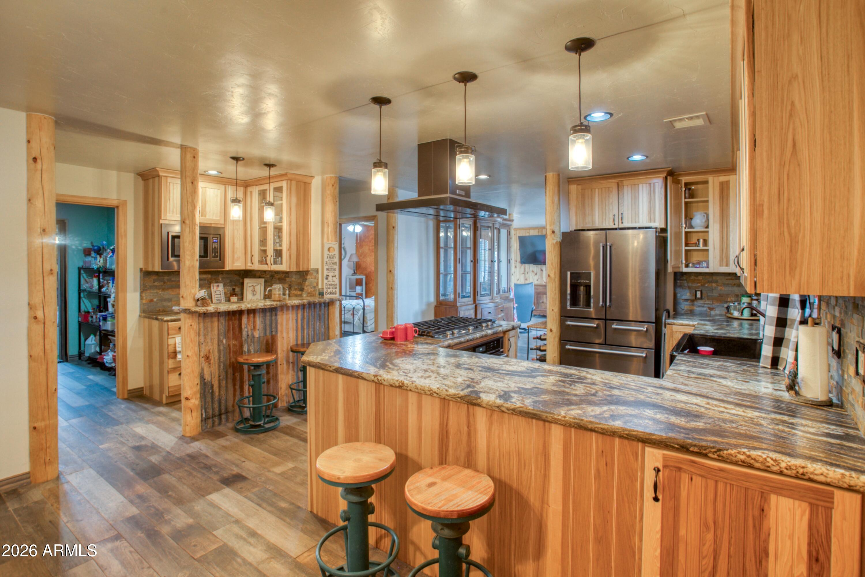5 Co Road Show Low, AZ 85901 - Photo 6 of 39 a kitchen with stainless steel appliances kitchen island granite countertop a table chairs and a refrigerator