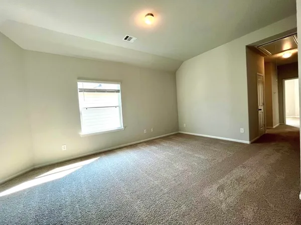 an empty room with windows and closet