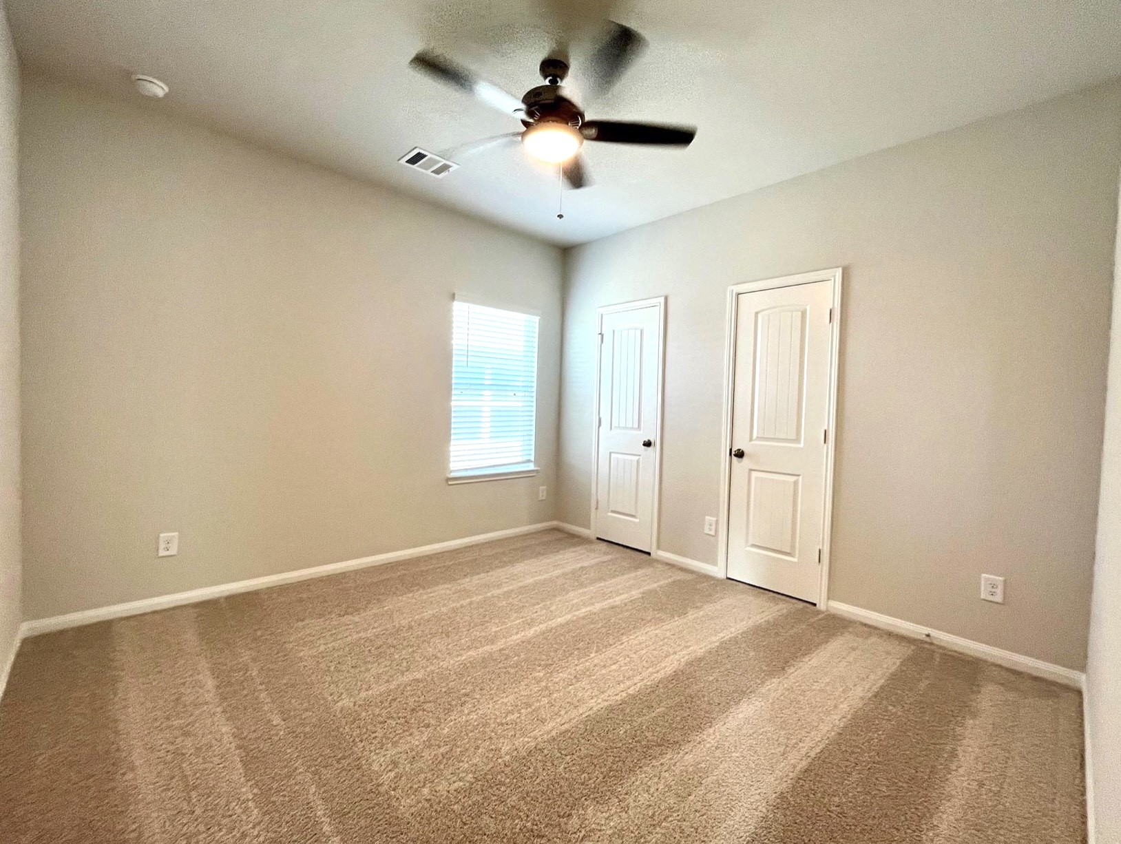 4814 Blue Jacaranda Way Spring, TX 77373 - Photo 14 of 19 a view of a room with a ceiling fan and window