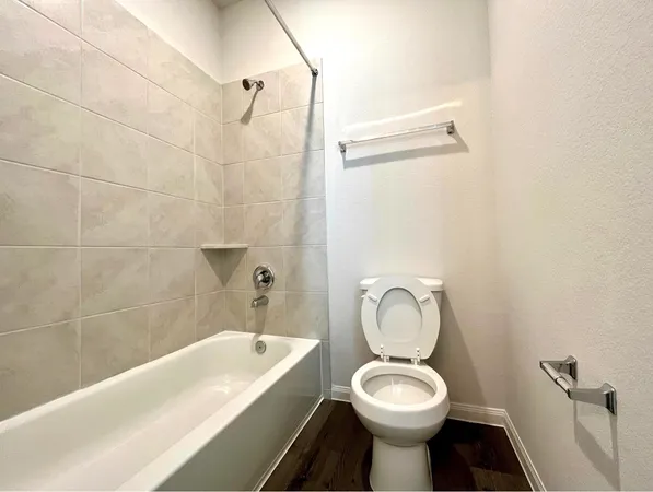 a bathroom with a toilet sink and bathtub