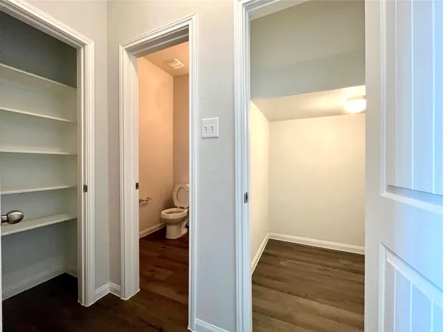 a view of closet with wooden floor