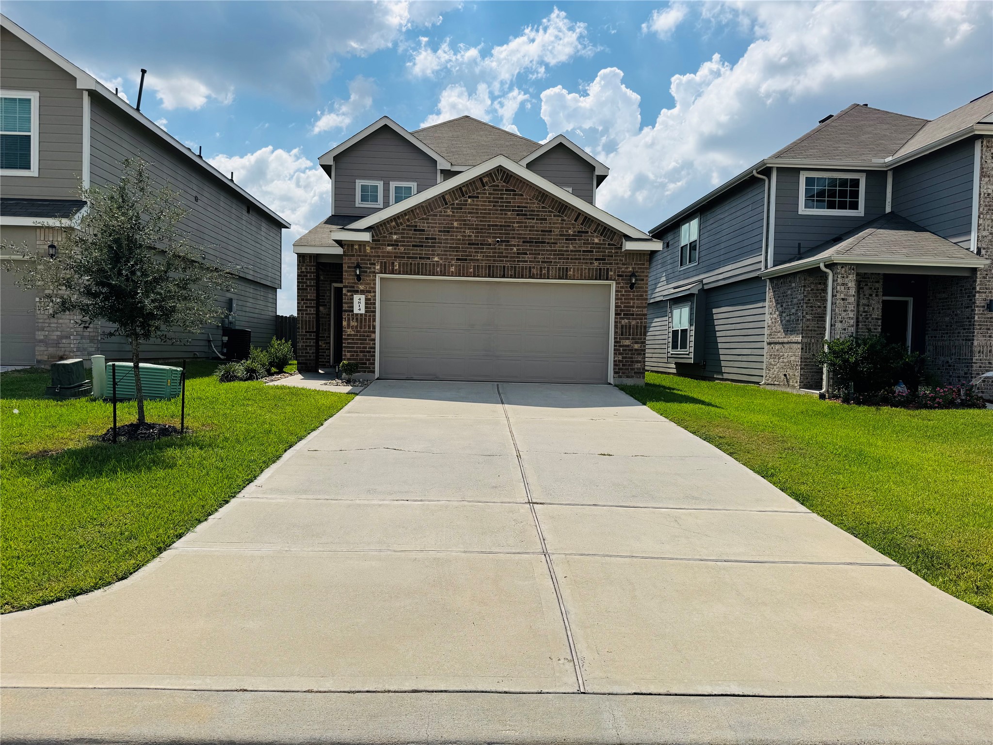 4814 Blue Jacaranda Way Spring, TX 77373 - Photo 2 of 19 a front view of a house with a yard and garage
