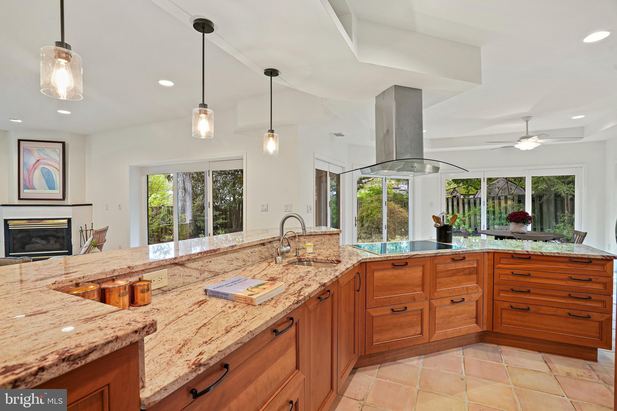 3112 Rolling Road Chevy Chase, MD 20815 - Photo 11 of 38 a large kitchen with kitchen island granite countertop a large window and a sink