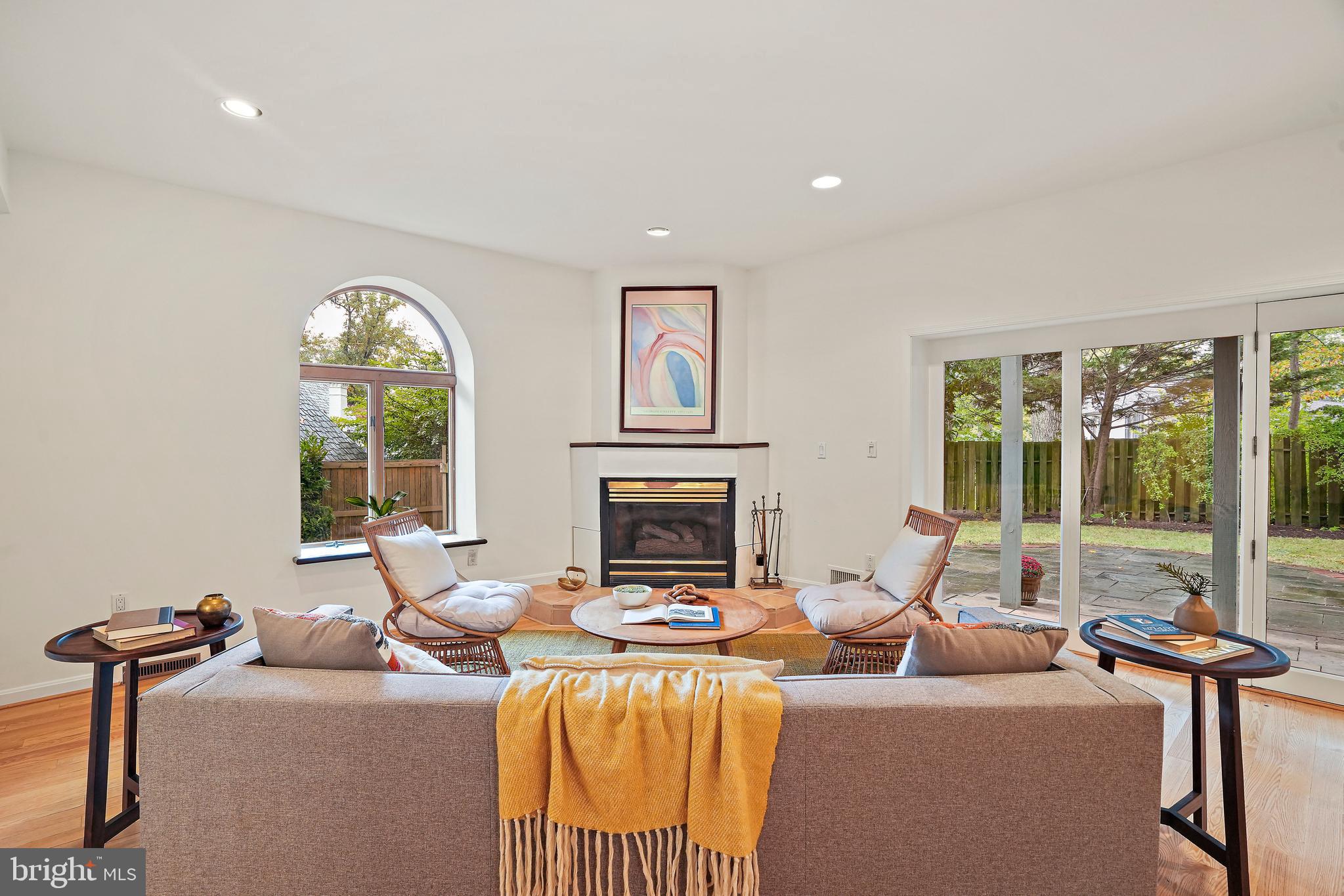 3112 Rolling Road Chevy Chase, MD 20815 - Photo 15 of 38 a living room with furniture a fireplace and a large window