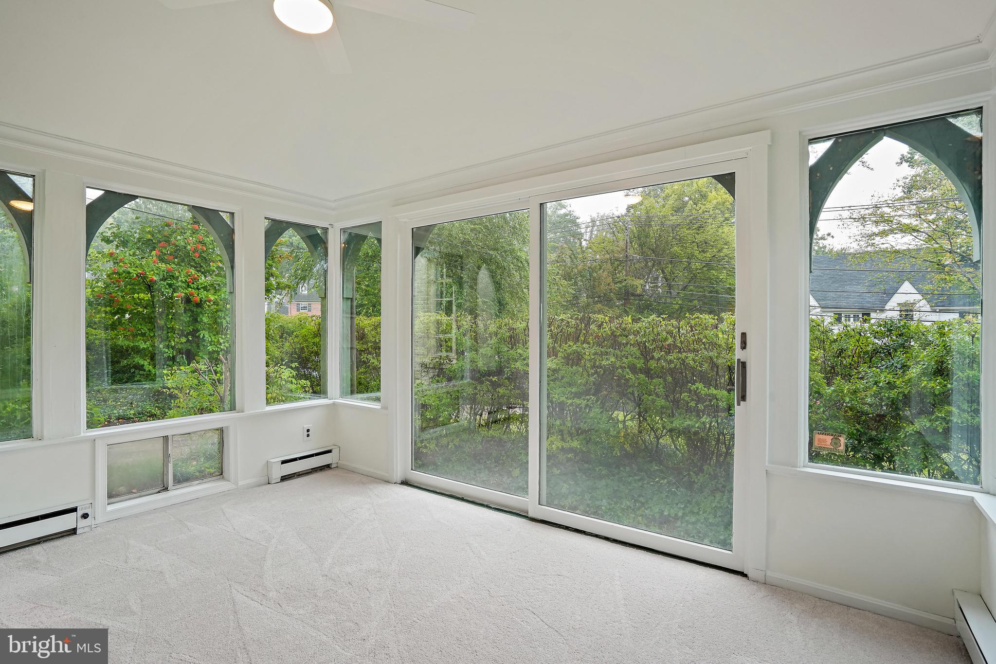 3112 Rolling Road Chevy Chase, MD 20815 - Photo 16 of 38 a view of an empty room with windows and yard