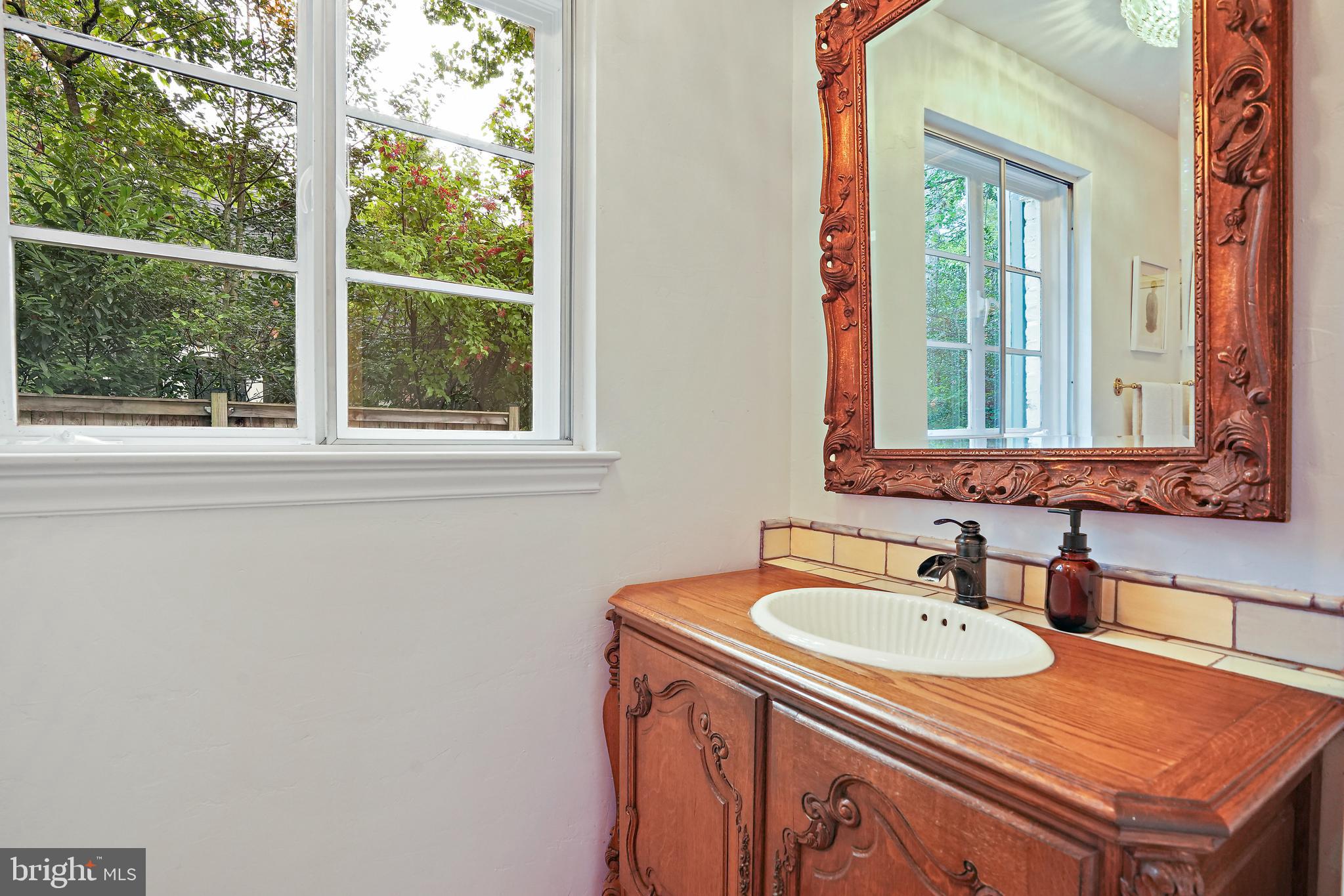 3112 Rolling Road Chevy Chase, MD 20815 - Photo 19 of 38 a bathroom with sink and a mirror