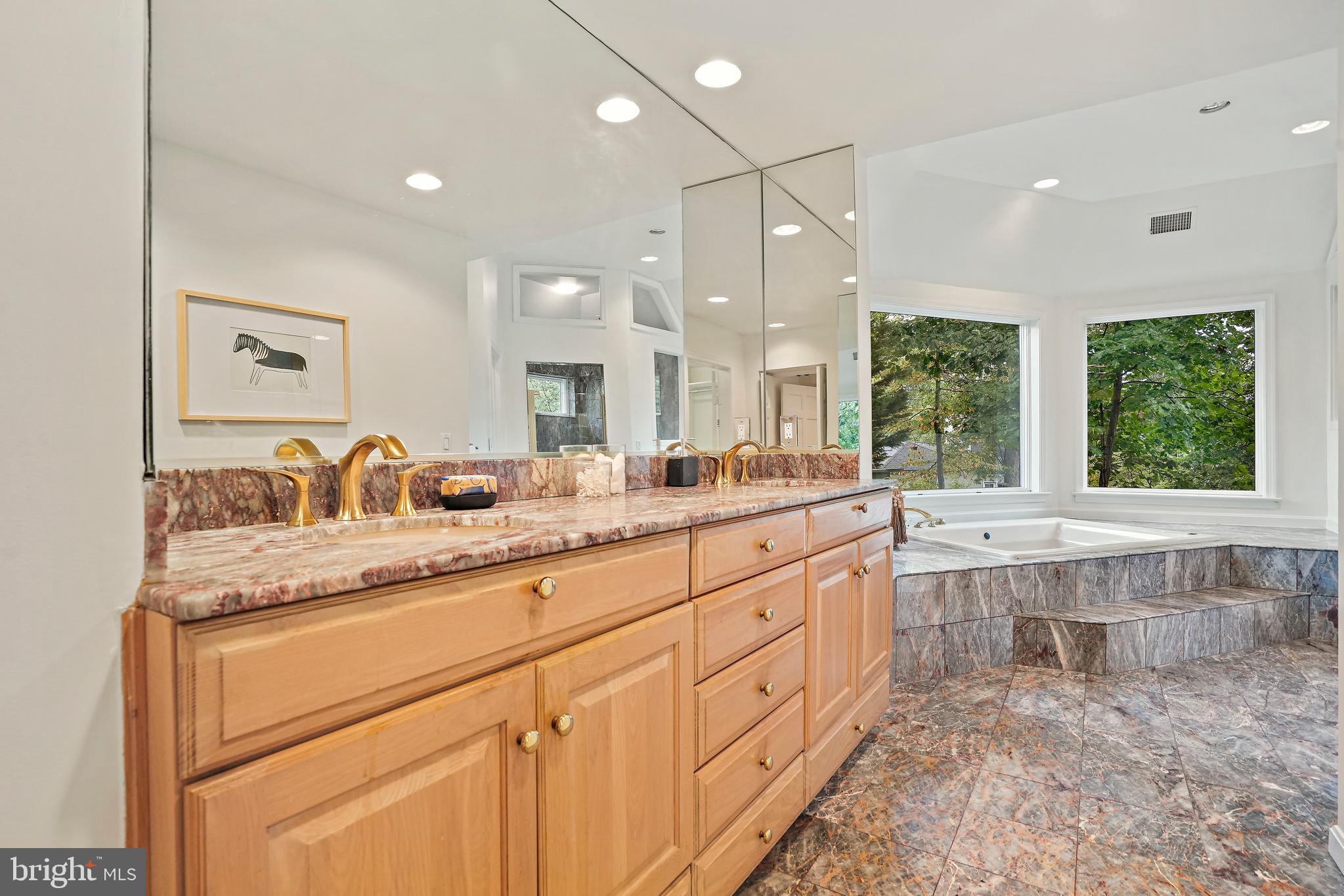 3112 Rolling Road Chevy Chase, MD 20815 - Photo 22 of 38 a large bathroom with a granite countertop sink and a large mirror