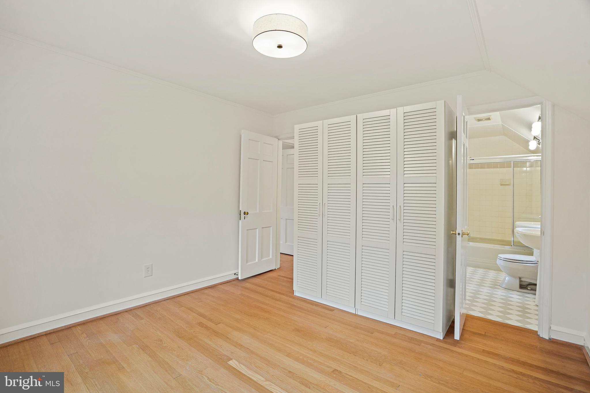 3112 Rolling Road Chevy Chase, MD 20815 - Photo 28 of 38 a view of empty room with wooden floor and shower