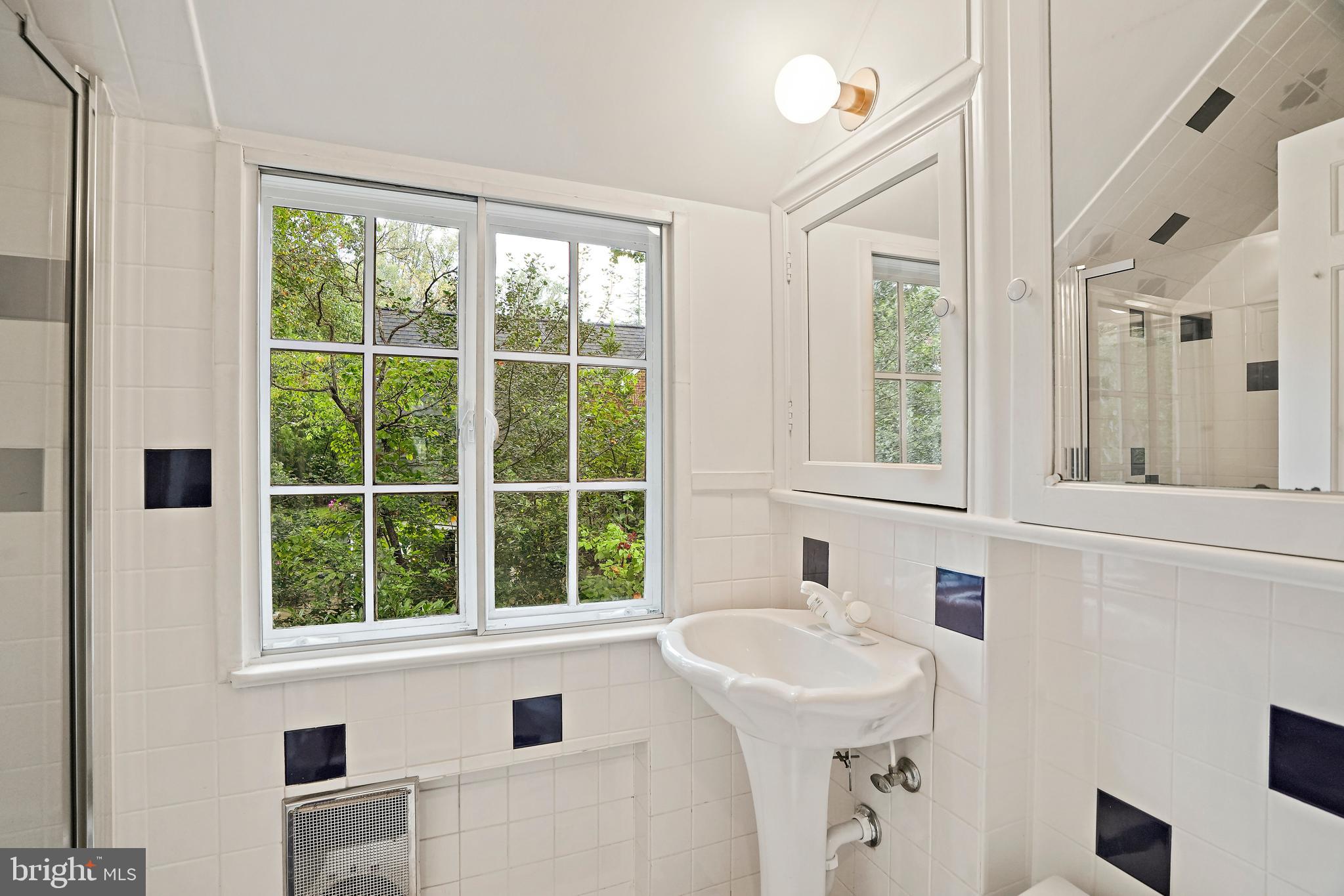 3112 Rolling Road Chevy Chase, MD 20815 - Photo 31 of 38 a bathroom with a sink and a window