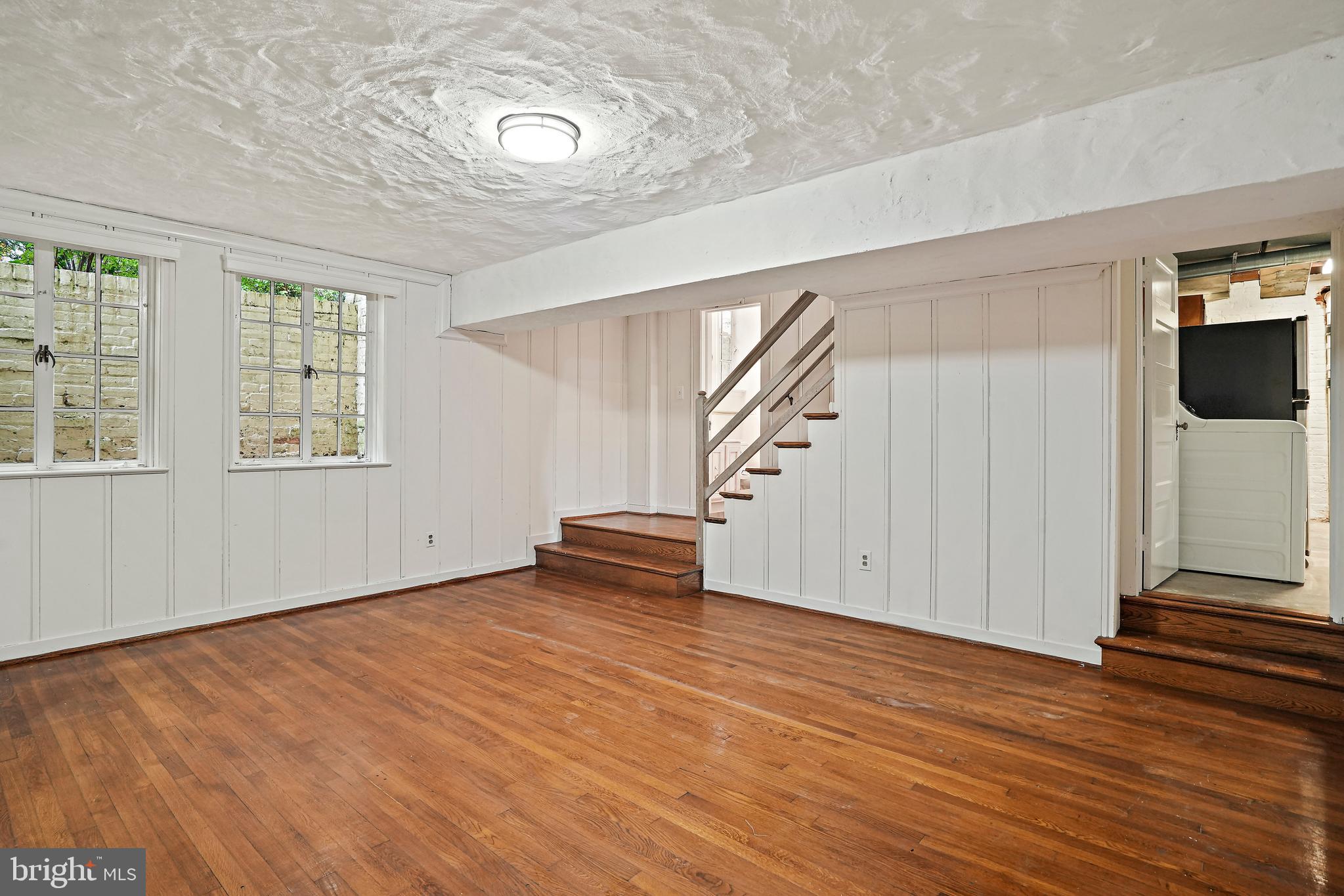 3112 Rolling Road Chevy Chase, MD 20815 - Photo 33 of 38 an empty room with wooden floor and windows