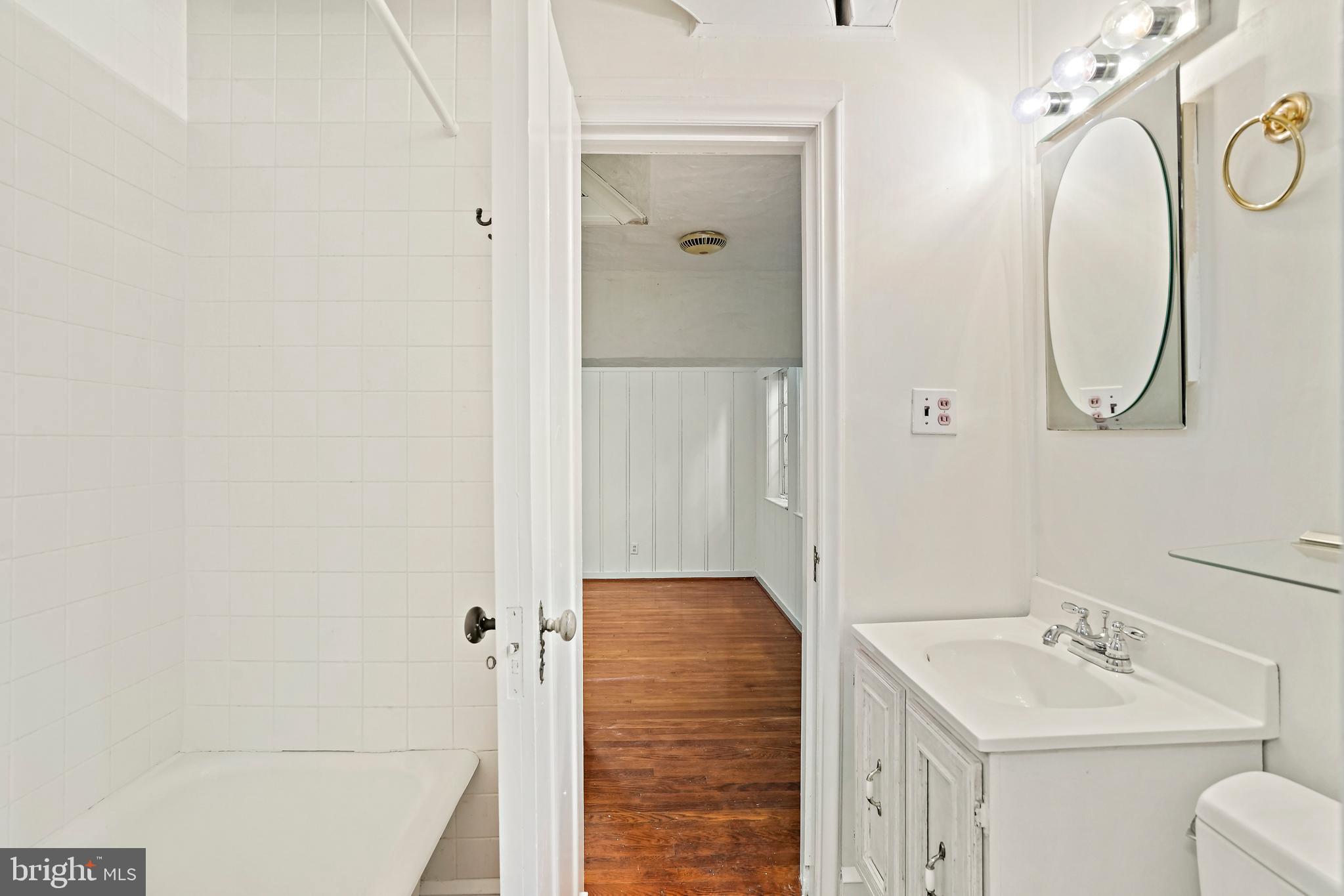 3112 Rolling Road Chevy Chase, MD 20815 - Photo 34 of 38 a bathroom with a sink a toilet and shower