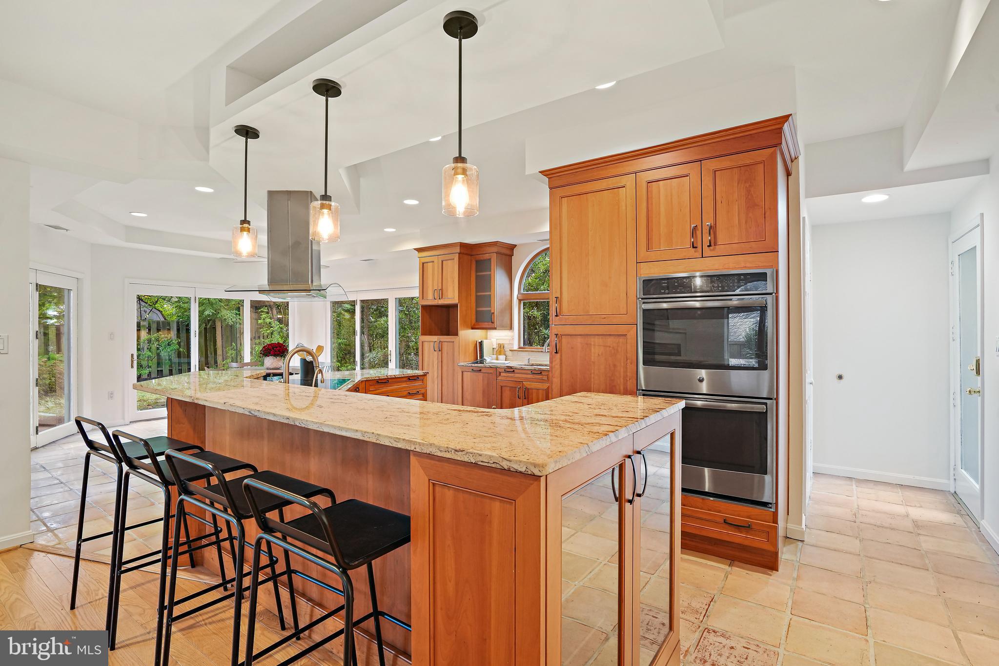 3112 Rolling Road Chevy Chase, MD 20815 - Photo 8 of 38 a large kitchen with a table and chairs