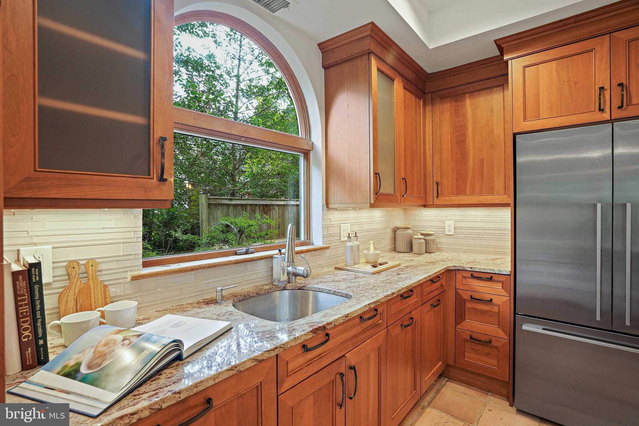 3112 Rolling Road Chevy Chase, MD 20815 - Photo 9 of 38 a kitchen with stainless steel appliances granite countertop a refrigerator and a sink