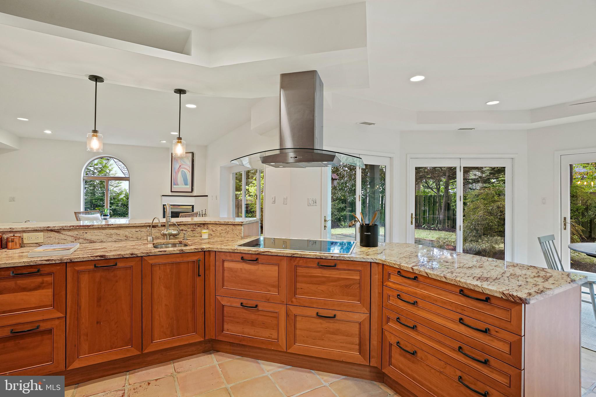 3112 Rolling Road Chevy Chase, MD 20815 - Photo 10 of 38 a kitchen with kitchen island granite countertop a sink and a wooden floors