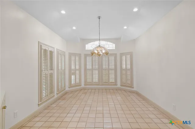 a kitchen with stainless steel appliances white cabinets and a stove top oven