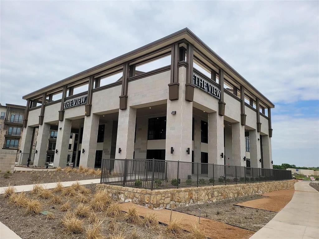 2700 Old Denton Road, Unit 2238 Carrollton, TX 75007 - Photo 1 of 21 Modern building exterior featuring prominent "THE VIEW" signage, light-toned stone cladding, and dark contrasting architectural accents