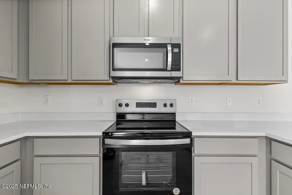 a stove top oven sitting inside of a kitchen