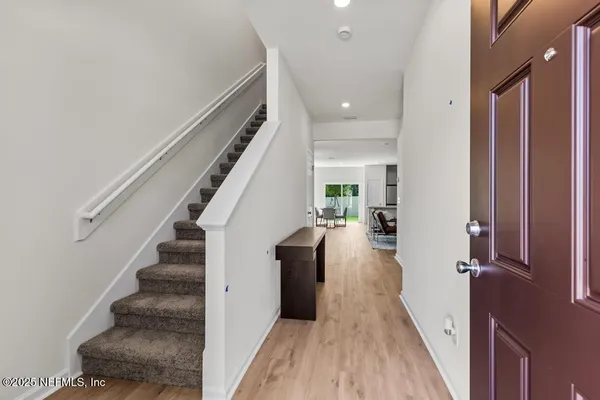 a view of entryway and hall with wooden floor
