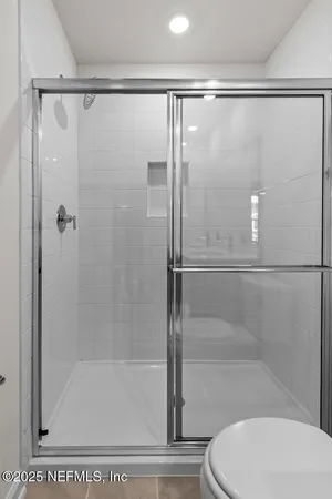 a bathroom with a shower and a toilet