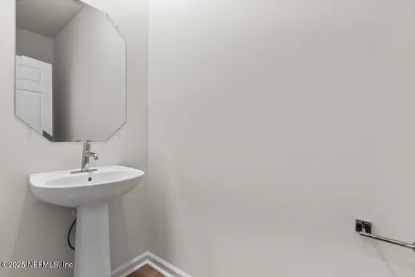 a bathroom with a sink a mirror and vanity