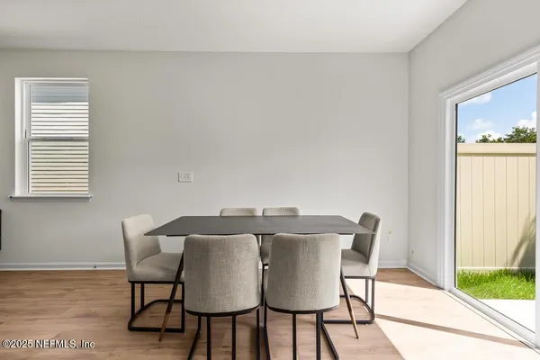 a view of a dining room with furniture and wooden floor