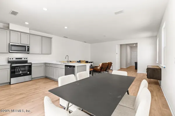 a kitchen with sink a microwave and cabinets
