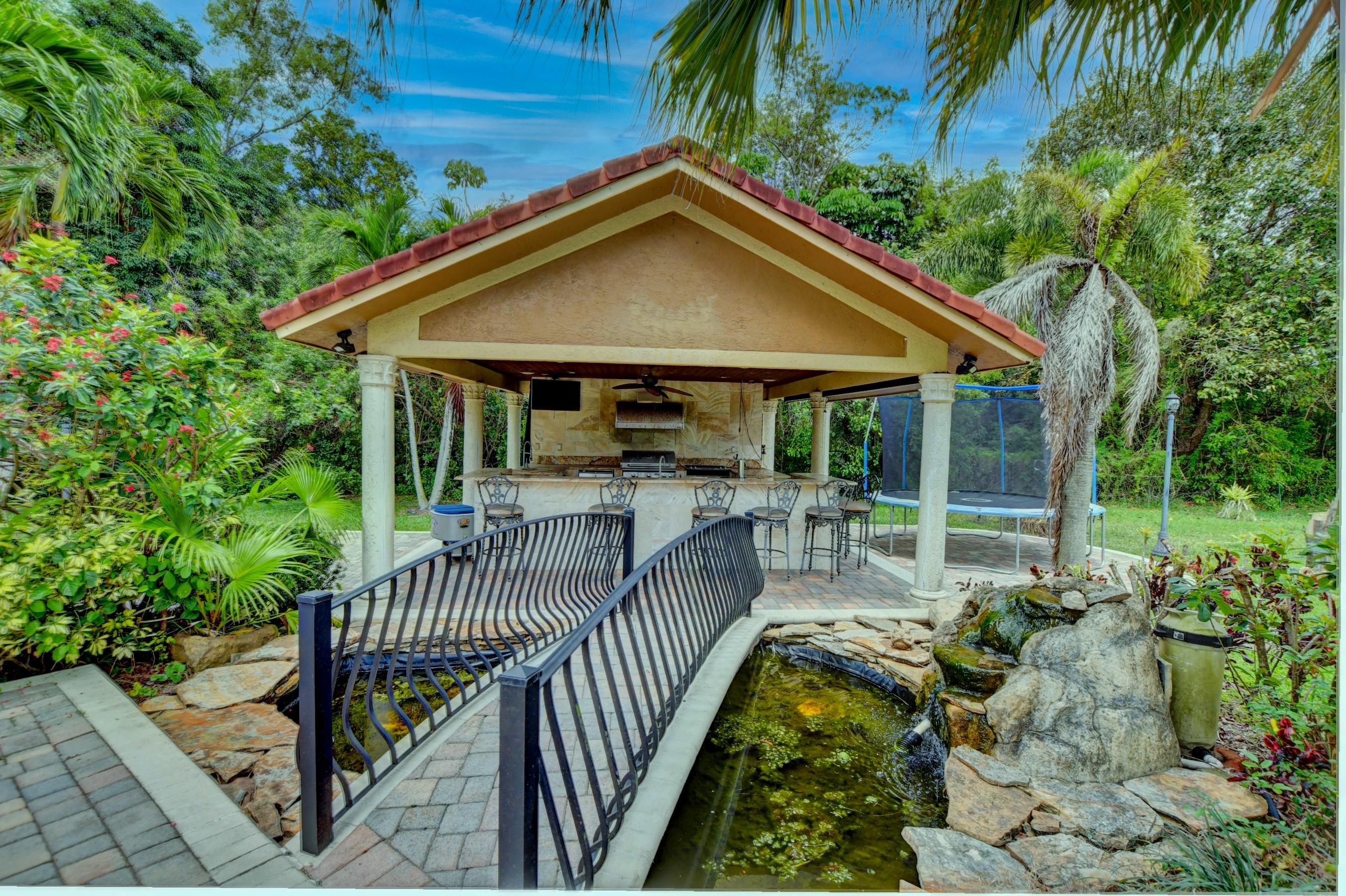 11301 Timber Lodge Terrace Boca Raton, FL 33428 - Photo 41 of 58 bridge/koi pond/outddor kitchen