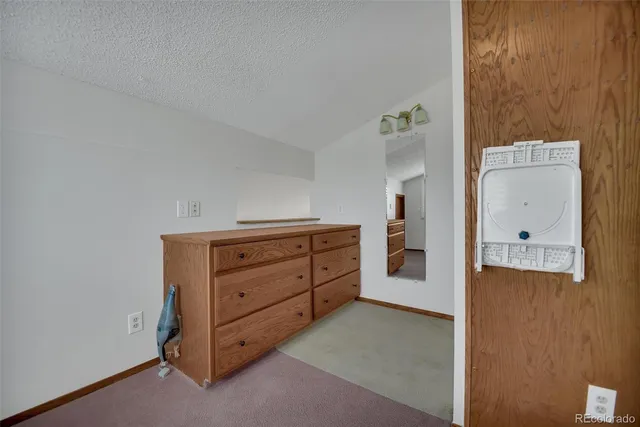 a bathroom with a granite countertop shower a mirror and a sink